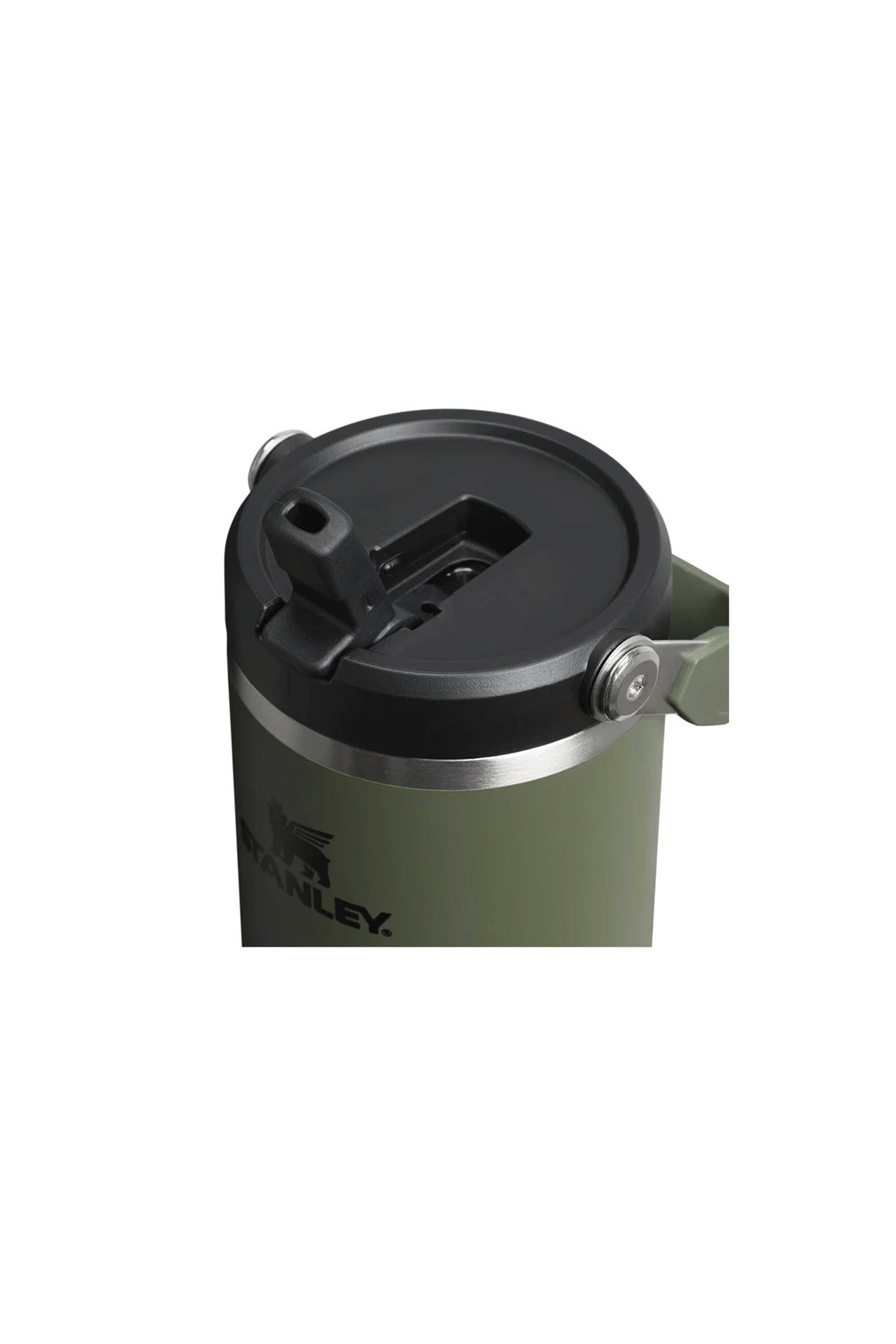 A close-up of the Stanley IceFlow Flip Straw Tumbler 30 OZ in green shows its black flip-top lid with sturdy metal hinges and double-wall vacuum insulation. The partially visible Stanley logo is on the side of the tumbler.